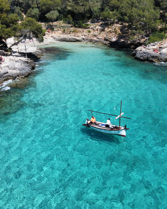 Llaut in Cala Serena with turquoise waters