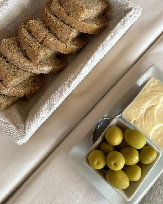 Slices of bread with aioli and olives