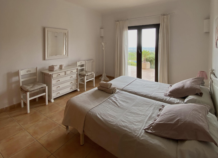 Room with two single beds and panoramic view